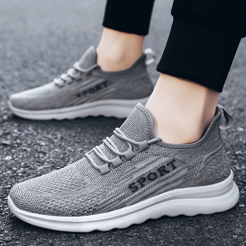 Gray stylish breathable elastic lace-up men's sneakers with mesh upper and low heel for comfort and style.